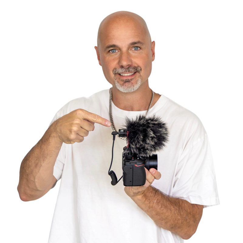 Justin McClure pointing to the Camera Vlog Mic on a camera